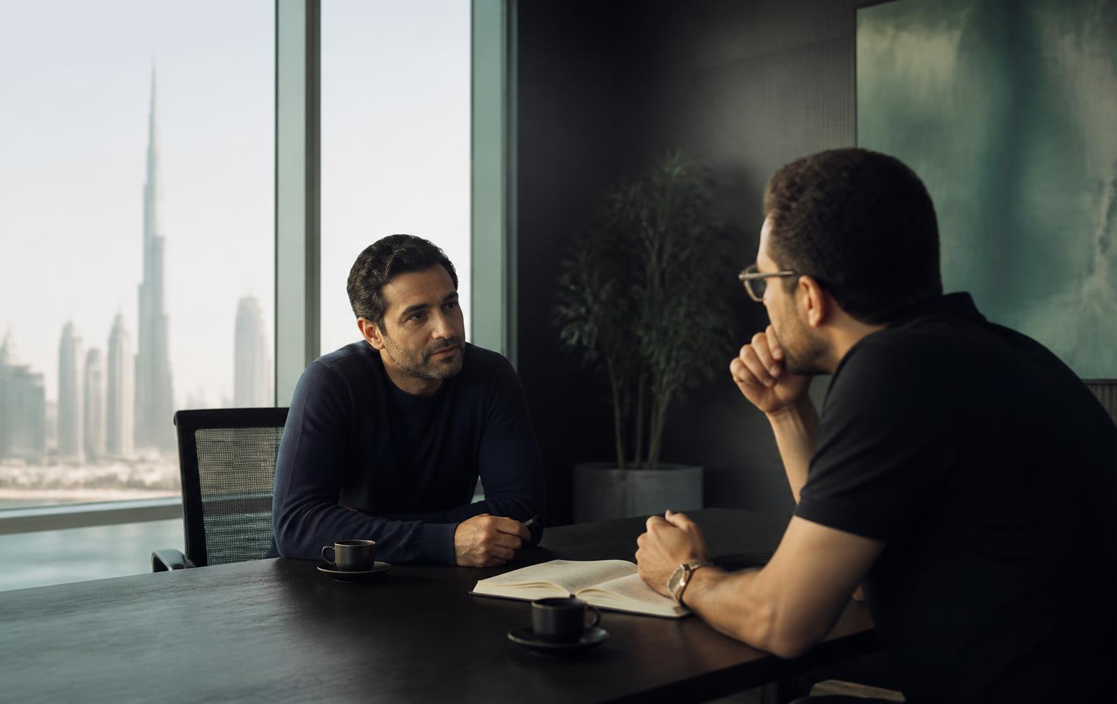 Two founders discussing business strategy across a table